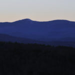 view of mountains from peak in Bristol NH just after sunset