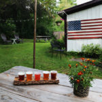 Woodman's Brewery in Bristol NH outdoor seating with tasting sampler